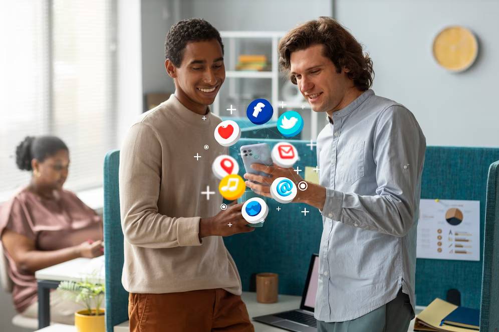 Two men engaging with a smartphone, showing social media icons, in a modern office setting.
